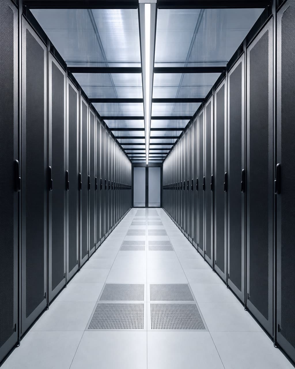 A wide cold aisle in a data hall with rows of closed racks on a raised floor and containment panels overhead